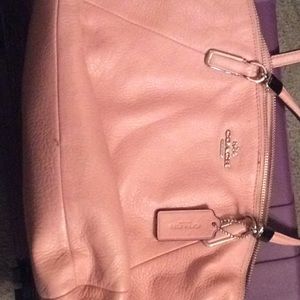 Coach purse with shoulder strap and hand strap.